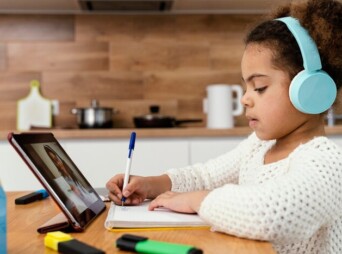 side-view-little-girl-during-online-school-with-tablet_23-2148827464